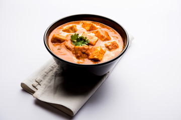 Paneer Butter Masala or Cheese Cottage Curry in serving a bowl or pan, served with or without roti and rice