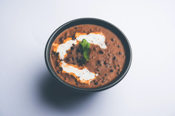 Dal makhani / makhni is a popular dish from India. Made with ingredients like whole black lentil, butter and cream. Served with Naan/roti and rice