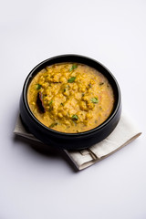 Dal Tadka Fry / Indian Lentil Curry served in a bowl with rice and roti, selective focus