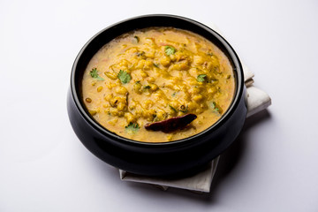 Dal Tadka Fry / Indian Lentil Curry served in a bowl with rice and roti, selective focus