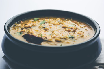 Dal Tadka Fry / Indian Lentil Curry served in a bowl with rice and roti, selective focus