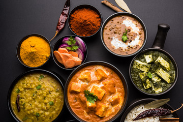 Indian Lunch / Dinner main course food in group includes Paneer Butter Masala, Dal Makhani, Palak Paneer, Roti, Rice etc, Selective focus