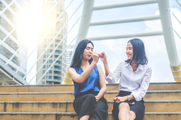 Concept of promise. Happy Young friend women holding hand together at city. Symbol of...