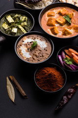 Indian Lunch / Dinner main course food in group includes Paneer Butter Masala, Dal Makhani, Palak Paneer, Roti, Rice etc, Selective focus