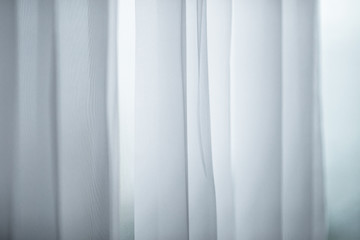 Obraz premium The background of the white curtains, modern design, often used in homes or resorts, hotels, restaurants, cafes, show products.