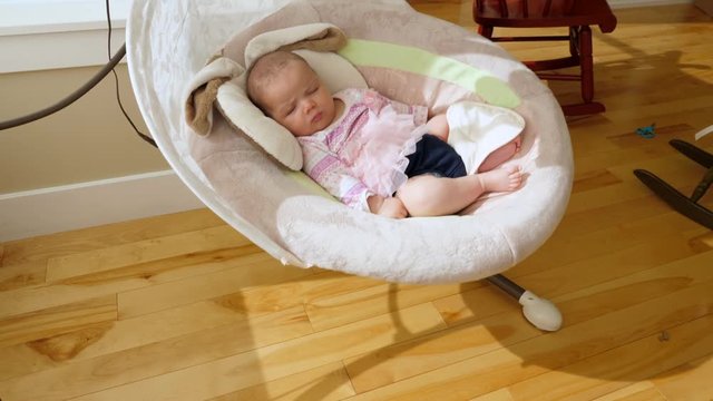Slow Motion Of Cute Baby Girl Swinging In A Bassinet