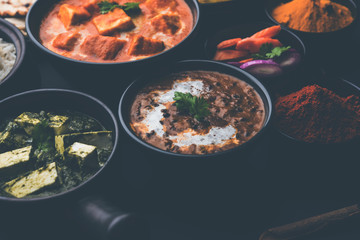 Indian Lunch / Dinner main course food in group includes Paneer Butter Masala, Dal Makhani, Palak Paneer, Roti, Rice etc, Selective focus