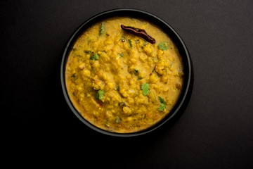 Dal Tadka Fry / Indian Lentil Curry served in a bowl with rice and roti, selective focus