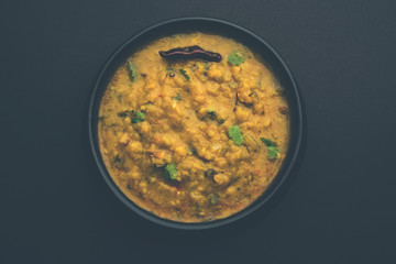 Dal Tadka Fry / Indian Lentil Curry served in a bowl with rice and roti, selective focus