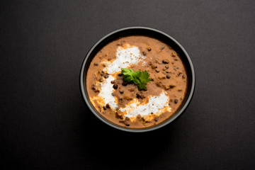 Dal makhani / makhni is a popular dish from India. Made with ingredients like whole black lentil, butter and cream. Served with Naan/roti and rice
