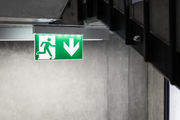 Escape way on staircase symbol, Illuminated sign of leakage in concrete building - 228282914
