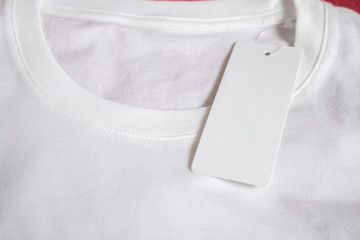 Blank price tag label on white t-shirt