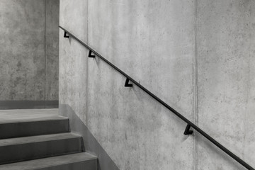 Concrete core with staircase and railing in a modern building, Elegant minimalist black steel...