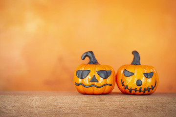 Halloween backgroun idea, funny Halloween pumpkin over blurred orange background