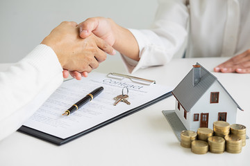 Real estate agent shaking hands with customer for deal contract to buy house, insurance or loan...
