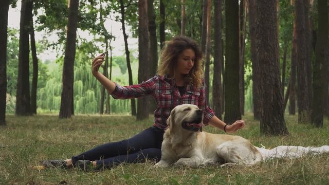 Pretty girl is making selfie with her Labrador