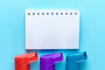 Asthma inhalers on a blue background. Copy space. Asthma and COPD disease concept