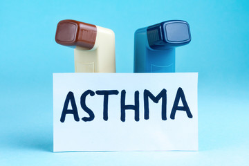 Various asthma inhalers on a blue background. Asthma and copd disease concept