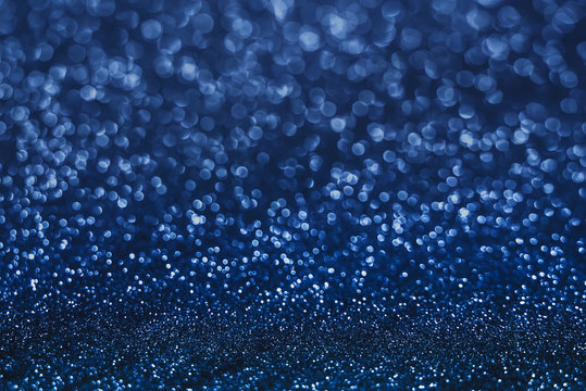 Dark deep navy blue celebrate blur bokeh abstract background. Festival glitter floor for graphic design.