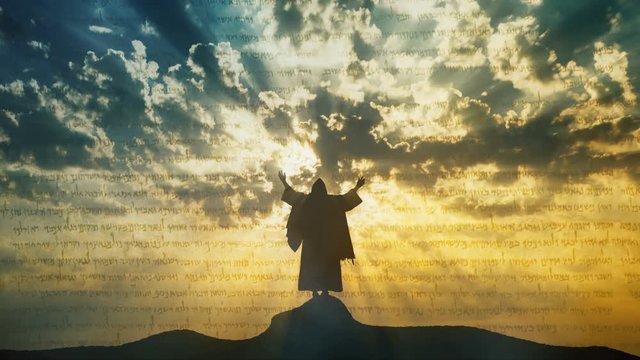Jesus silhouette standing on hill crest with sun and clouds behind Him. Representation of a prophet's dreams or vision.