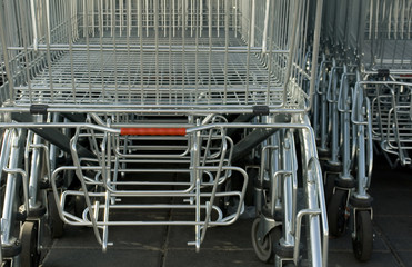 row of shopping carts, outside a large supermarket, used to hold food that is bought by customers to eat, in metal and plastic, online, ecommerce, bills, receipt, consumers, italy