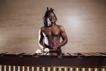 rastafarian man plays the marimba - obrazy, fototapety, plakaty
