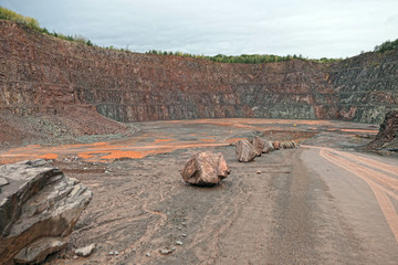 Aerial view into a quarry mine of porphyry rocks.