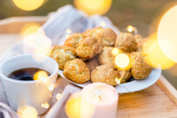 Coffee table with coffee cup, cookies and candle шт the evening