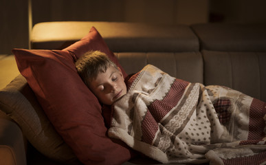 Cute boy sleeping on the sofa