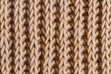 The texture of brown knitted yarn. Knitted and winter clothes