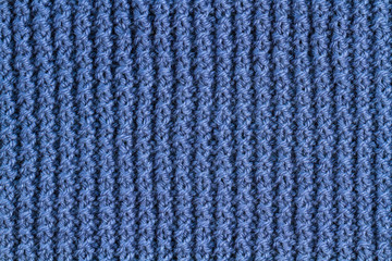 The texture of a blue knitted yarn. Knitted and winter clothes