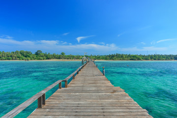 Long wooden bridge go to island on the sea in beautiful tropical island, Thailand..