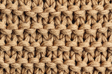 The texture of a brown knitted yarn. Knitted and winter clothes