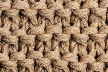 The texture of a brown knitted yarn. Knitted and winter clothes