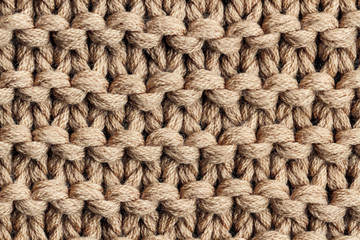 The texture of a brown knitted yarn. Knitted and winter clothes