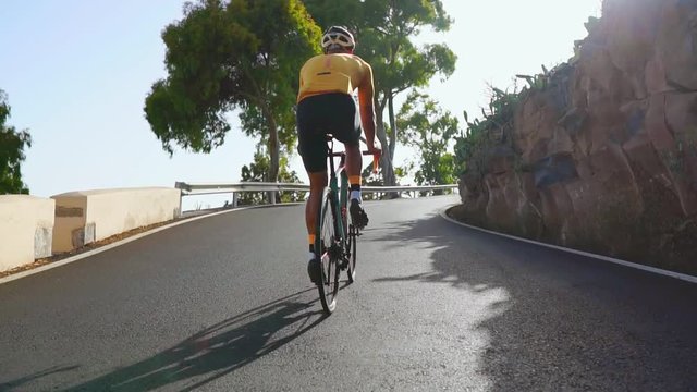 Man cycling on road bike outdoor exercise on an empty road in the morning .Extreme sport concept. Slow motion