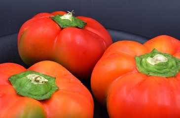 Red peppers on black background.