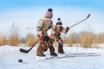 Boys play hockey on a frozen lake