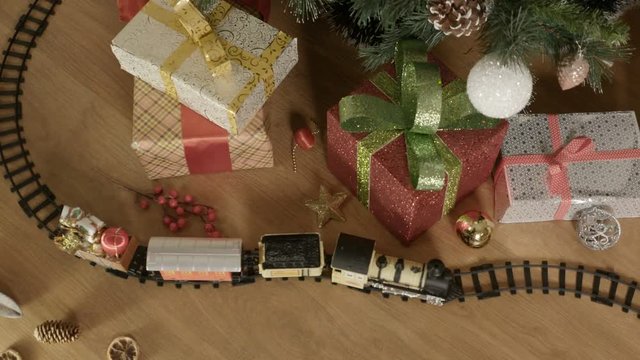 A beautiful toy steam train on the floor. 
Top view. Christmas – New Year Gift