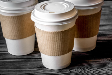 coffee cup to go at wooden background