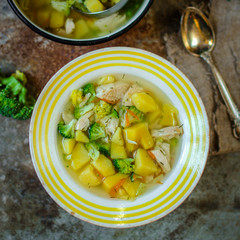 soup with broccoli, chicken and vegetables (on the table) on gray background. . top view. food background