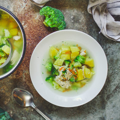 soup with broccoli, chicken and vegetables (on the table) on gray background. . top view. food background