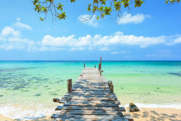 Long wooden bridge go to the sea in beautiful tropical island, Thailand.