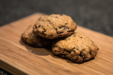Freshly baked chocolate chip cookies on a wooden surface
