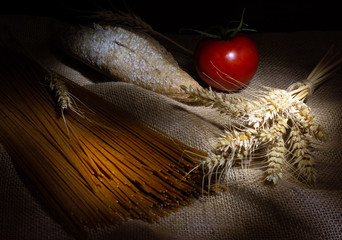 Wholemeal pasta and bread on rustic background