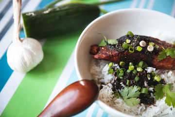 Salmon Teriyaki on a white bowl and stripes background