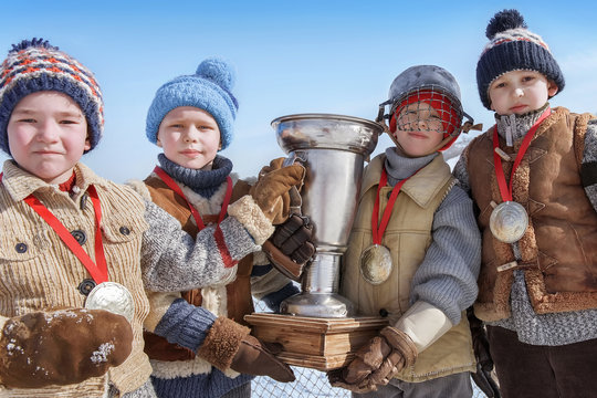 Portrait Of Young Hockey Players With A Cup