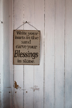 Inspirational board on white wooden wall