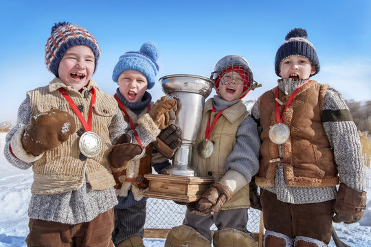 Portrait of young hockey players with a cup