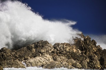 Dramatic big stormy crashing waves splash. Kleinmond, Western Cape, South Africa.